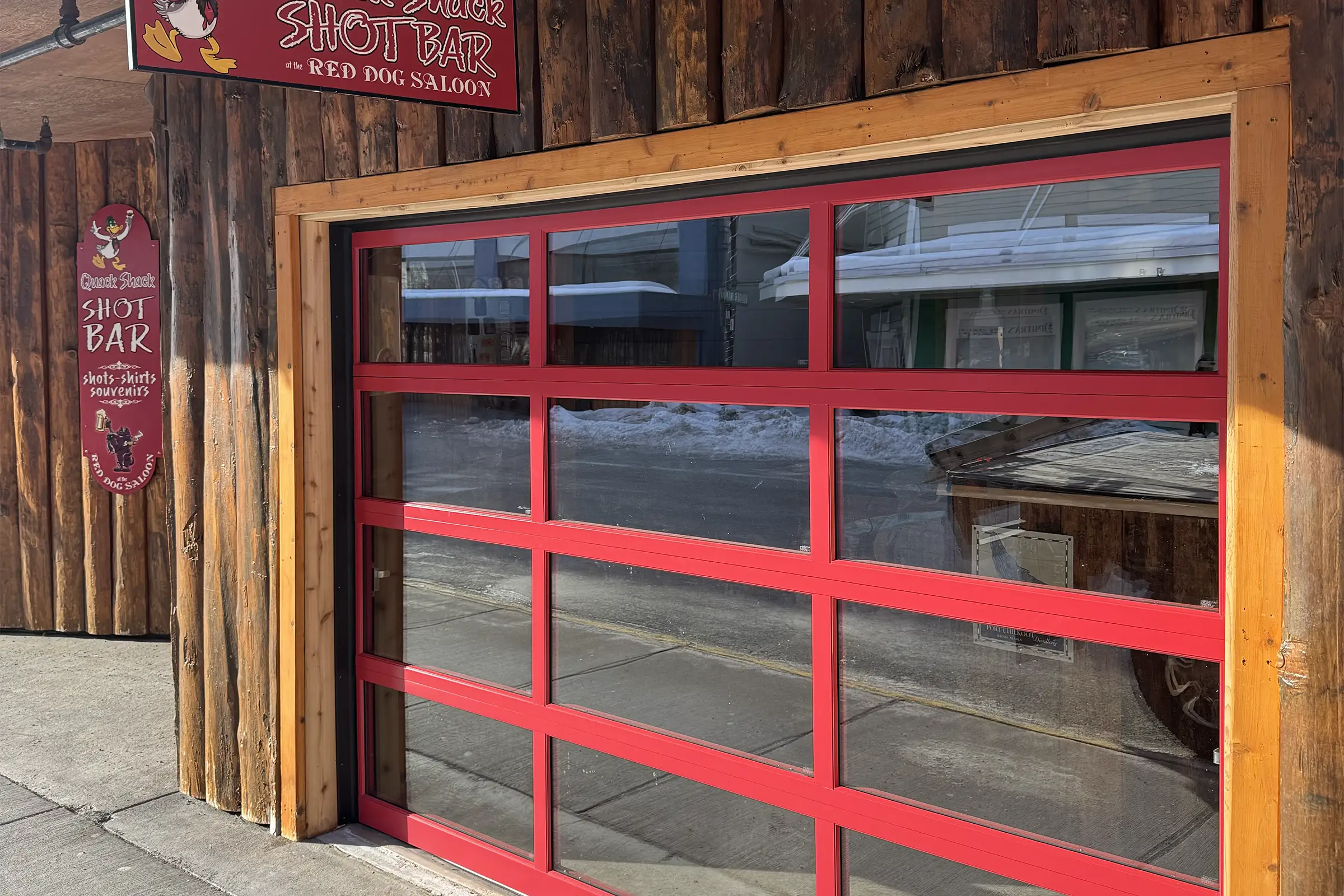 Red-frame full-view glass garage door at the Red Dog Saloon in downtown Juneau